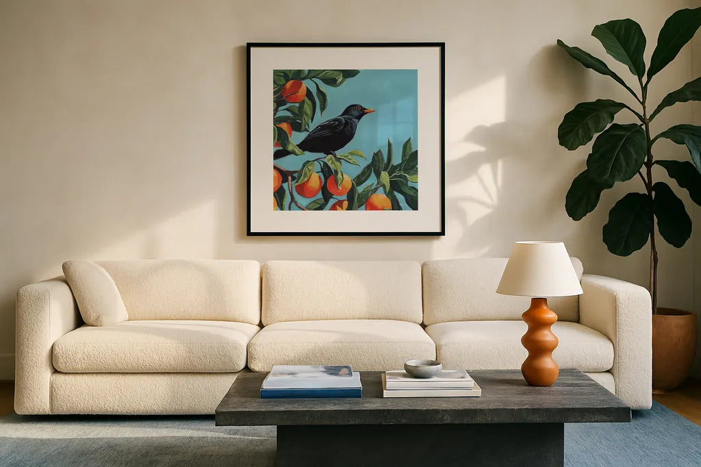 Black Bird On Orange Branch by Kate Jarvik Birch. Displayed in a glass frame with matte in a clean modern living room. Available as an archival giclee rolled canvas, fine art paper, or poster print. SKU 101986a.