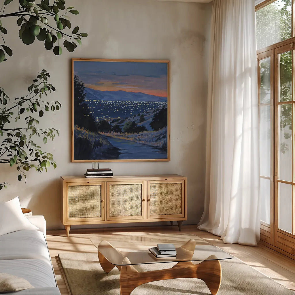 Desert City Lights at Dusk by Kate Jarvik Birch. Shown in a natural wood frame in a cozy modern living room. Available as an archival giclee rolled canvas, fine art paper, or poster print. SKU 98566a.