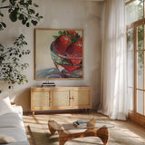 Glass Bowl Of Strawberries by Kate Jarvik Birch. Shown in a natural wood frame in a cozy modern living room. Available as an archival giclee rolled canvas, fine art paper, or poster print. SKU 101992a.