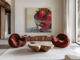 Glass Bowl Of Strawberries by Kate Jarvik Birch. Shown as extra-large giant wall art in a modern living room. Available as an archival giclee rolled canvas, fine art paper, or poster print. SKU 101992a.