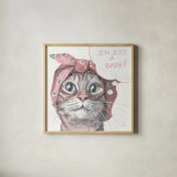 Just a Baby Cat Pink by Kate Jarvik Birch. Shown in a natural wood glass frame for a timeless modern aesthetic. Available as an archival giclee rolled canvas, fine art paper, or poster print. SKU 104153a.