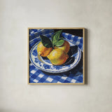 Lemons on a Blue Table by Kate Jarvik Birch. Shown in a natural wood glass frame for a timeless modern aesthetic. Available as an archival giclee rolled canvas, fine art paper, or poster print. SKU 100948a.