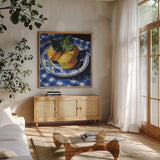 Lemons on a Blue Table by Kate Jarvik Birch. Shown in a natural wood frame in a cozy modern living room. Available as an archival giclee rolled canvas, fine art paper, or poster print. SKU 100948a.