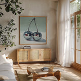Metallic Cherries by Kate Jarvik Birch. Shown in a natural wood frame in a cozy modern living room. Available as an archival giclee rolled canvas, fine art paper, or poster print. SKU 99770a.