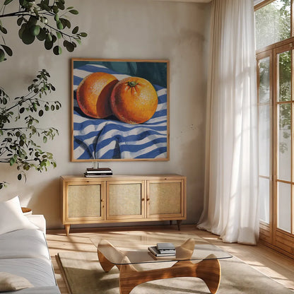 Oranges on Striped Cloth by Kate Jarvik Birch. Shown in a natural wood frame in a cozy modern living room. Available as an archival giclee rolled canvas, fine art paper, or poster print. SKU 98607a.