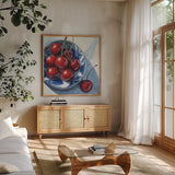 Overhead View of Cherries by Kate Jarvik Birch. Shown in a natural wood frame in a cozy modern living room. Available as an archival giclee rolled canvas, fine art paper, or poster print. SKU 102909a.