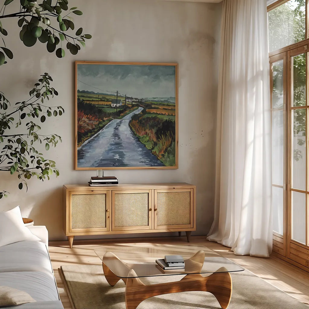 Rainy Back Road by Kate Jarvik Birch. Shown in a natural wood frame in a cozy modern living room. Available as an archival giclee rolled canvas, fine art paper, or poster print. SKU 100956a.