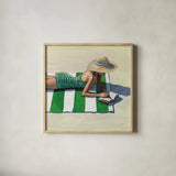 Reading at The Beach v2 by Kate Jarvik Birch. Shown in a natural wood glass frame for a timeless modern aesthetic. Available as an archival giclee rolled canvas, fine art paper, or poster print. SKU 100782a.
