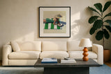 Reading at The Beach v2 by Kate Jarvik Birch. Displayed in a glass frame with matte in a clean modern living room. Available as an archival giclee rolled canvas, fine art paper, or poster print. SKU 100782a.