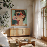 Retro Bubblegum Girl Teal by Kate Jarvik Birch. Shown in a natural wood frame in a cozy modern living room. Available as an archival giclee rolled canvas, fine art paper, or poster print. SKU 100021a.