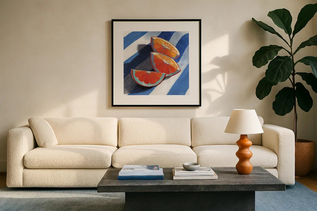 Three Citrus Slices by Kate Jarvik Birch. Displayed in a glass frame with matte in a clean modern living room. Available as an archival giclee rolled canvas, fine art paper, or poster print. SKU 100964a.