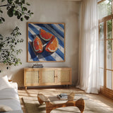 Three Citrus Slices II by Kate Jarvik Birch. Shown in a natural wood frame in a cozy modern living room. Available as an archival giclee rolled canvas, fine art paper, or poster print. SKU 101994a.