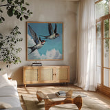 Two Birds in The Clouds by Kate Jarvik Birch. Shown in a natural wood frame in a cozy modern living room. Available as an archival giclee rolled canvas, fine art paper, or poster print. SKU 99769a.