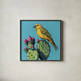 Yellow Bird on Cacti Bloom by Kate Jarvik Birch. Shown in a sleek black glass frame for a contemporary gallery look. Available as an archival giclee rolled canvas, fine art paper, or poster print. SKU 98543a.