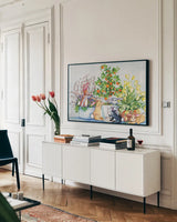 Bunnies by Kathleen Parr McKenna. shown as a framed stretched canvas in a living room above a console. Available as a archival giclee rolled canvas, fine art paper, or poster print. SKU 41207i.