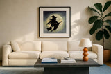Haunting Halloween Night Witch by Kathleen Parr McKenna. Displayed in a glass frame with matte in a clean modern living room. Available as an archival giclee rolled canvas, fine art paper, or poster print. SKU 53220a.