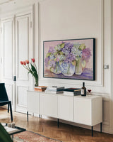 Hydrangeas In Glass by Kathleen Parr McKenna. shown as a framed stretched canvas in a living room above a console. Available as a archival giclee rolled canvas, fine art paper, or poster print. SKU 88421i.