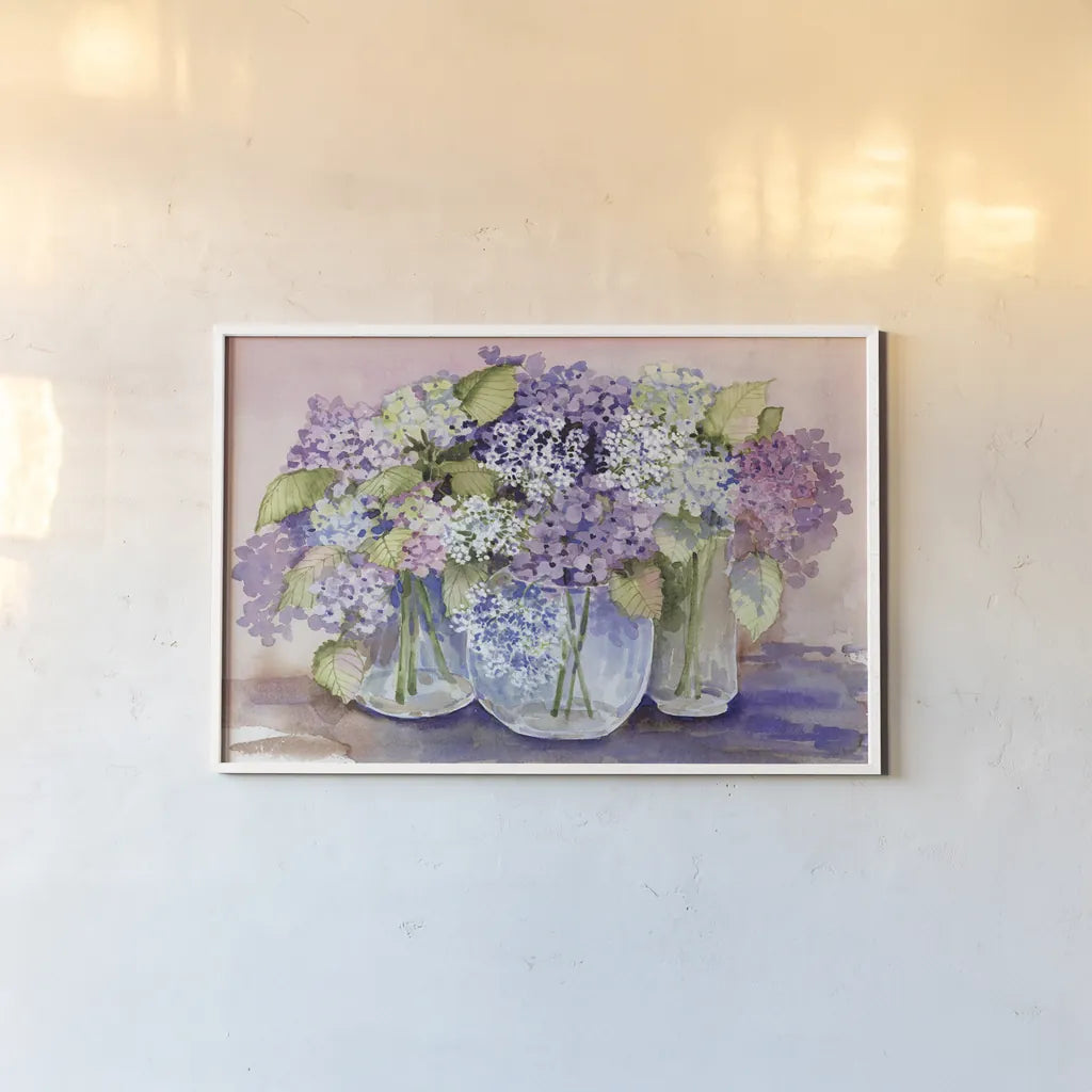 Hydrangeas In Glass by Kathleen Parr McKenna. shown as a paper print in a white frame. Available as a archival giclee rolled canvas, fine art paper, or poster print. SKU 88421i.
