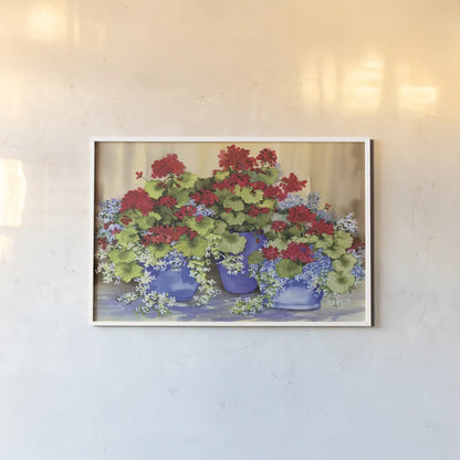 Red Geraniums with The Blues by Kathleen Parr McKenna. shown as a paper print in a white frame. Available as a archival giclee rolled canvas, fine art paper, or poster print. SKU 88422i.