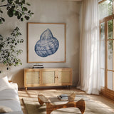 Shells IV Blue and White by Kathleen Parr McKenna. Shown in a natural wood frame in a cozy modern living room. Available as an archival giclee rolled canvas, fine art paper, or poster print. SKU 40558a.