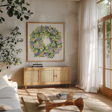 Spring Wreath IV by Kathleen Parr McKenna. Shown in a natural wood frame in a cozy modern living room. Available as an archival giclee rolled canvas, fine art paper, or poster print. SKU 24599a.