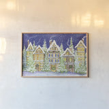 Village Christmas by Kathleen Parr McKenna. shown as a paper print in a natural frame. Available as a archival giclee rolled canvas, fine art paper, or poster print. SKU 41394i.