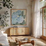 Decorative Hydrangea II Providence by Kathrine Lovell. Shown in a natural wood frame in a cozy modern living room. Available as an archival giclee rolled canvas, fine art paper, or poster print. SKU 82163a.