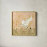 Egret Alighting II Flipped by Kathrine Lovell. Shown in a natural wood glass frame for a timeless modern aesthetic. Available as an archival giclee rolled canvas, fine art paper, or poster print. SKU 68083a.