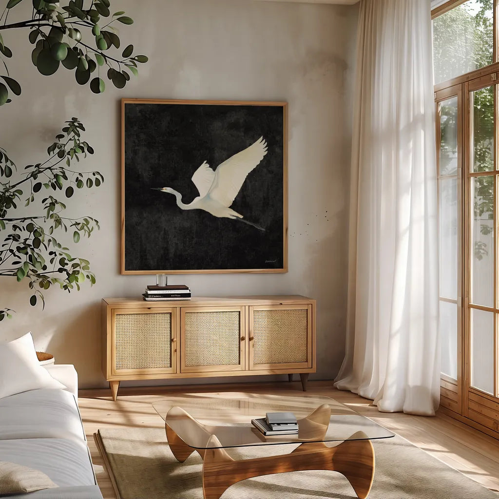 Egret Alighting II Flipped Black by Kathrine Lovell. Shown in a natural wood frame in a cozy modern living room. Available as an archival giclee rolled canvas, fine art paper, or poster print. SKU 79055a.