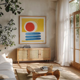 Primary Sunrise II by Kathrine Lovell. Shown in a natural wood frame in a cozy modern living room. Available as an archival giclee rolled canvas, fine art paper, or poster print. SKU 84781a.