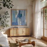 Abstract Layers I Blue by Kathy Ferguson. Shown in a natural wood frame in a cozy modern living room. Available as an archival giclee rolled canvas, fine art paper, or poster print. SKU 72692a.
