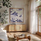 Botanical Blue II by Katie Pertiet. Shown in a natural wood frame in a cozy modern living room. Available as an archival giclee rolled canvas, fine art paper, or poster print. SKU 42173a.