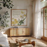 Citron Curiosities IV by Katie Pertiet. Shown in a natural wood frame in a cozy modern living room. Available as an archival giclee rolled canvas, fine art paper, or poster print. SKU 36939a.