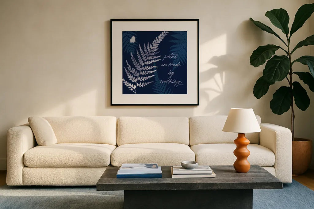 Dark True Blue III by Katie Pertiet. Displayed in a glass frame with matte in a clean modern living room. Available as an archival giclee rolled canvas, fine art paper, or poster print. SKU 66619a.