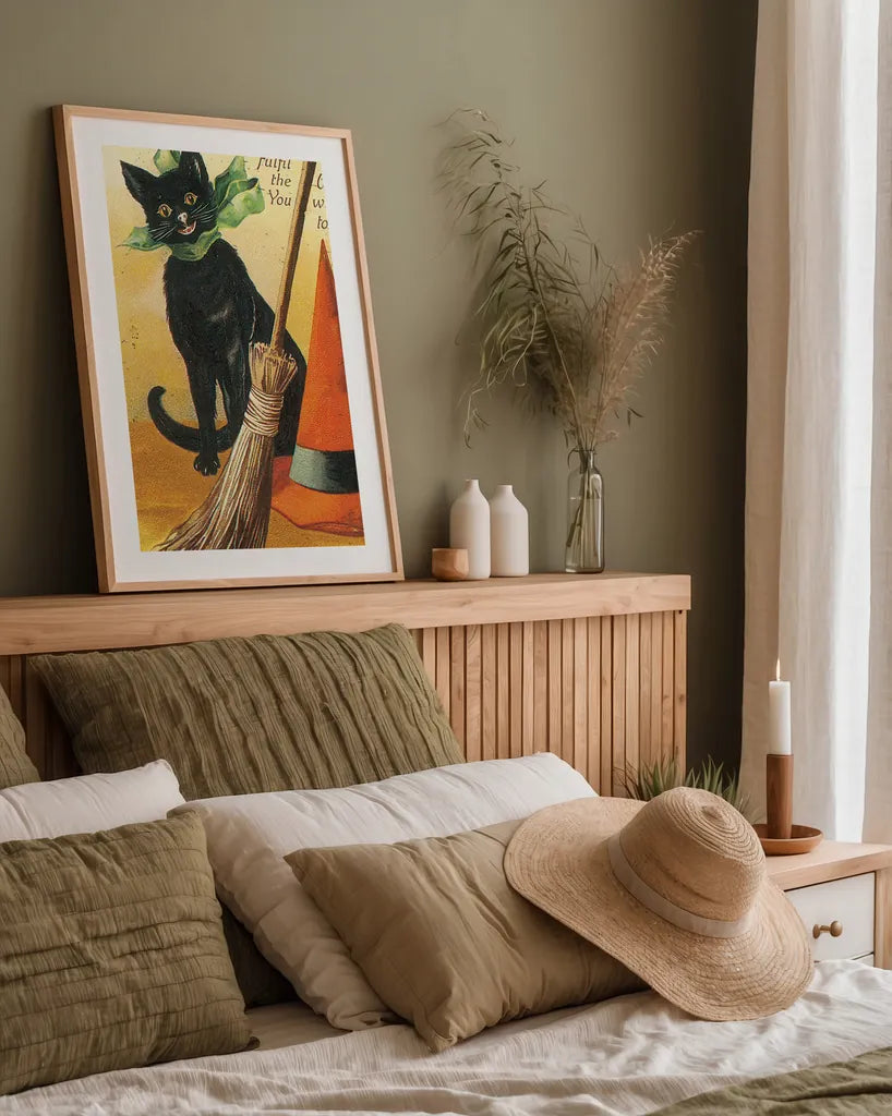 Halloween Nostalgia Cat with Broom by Katie Pertiet. shown as a paper print in a natural frame. Available as a archival giclee rolled canvas, fine art paper, or poster print. SKU 57290h.