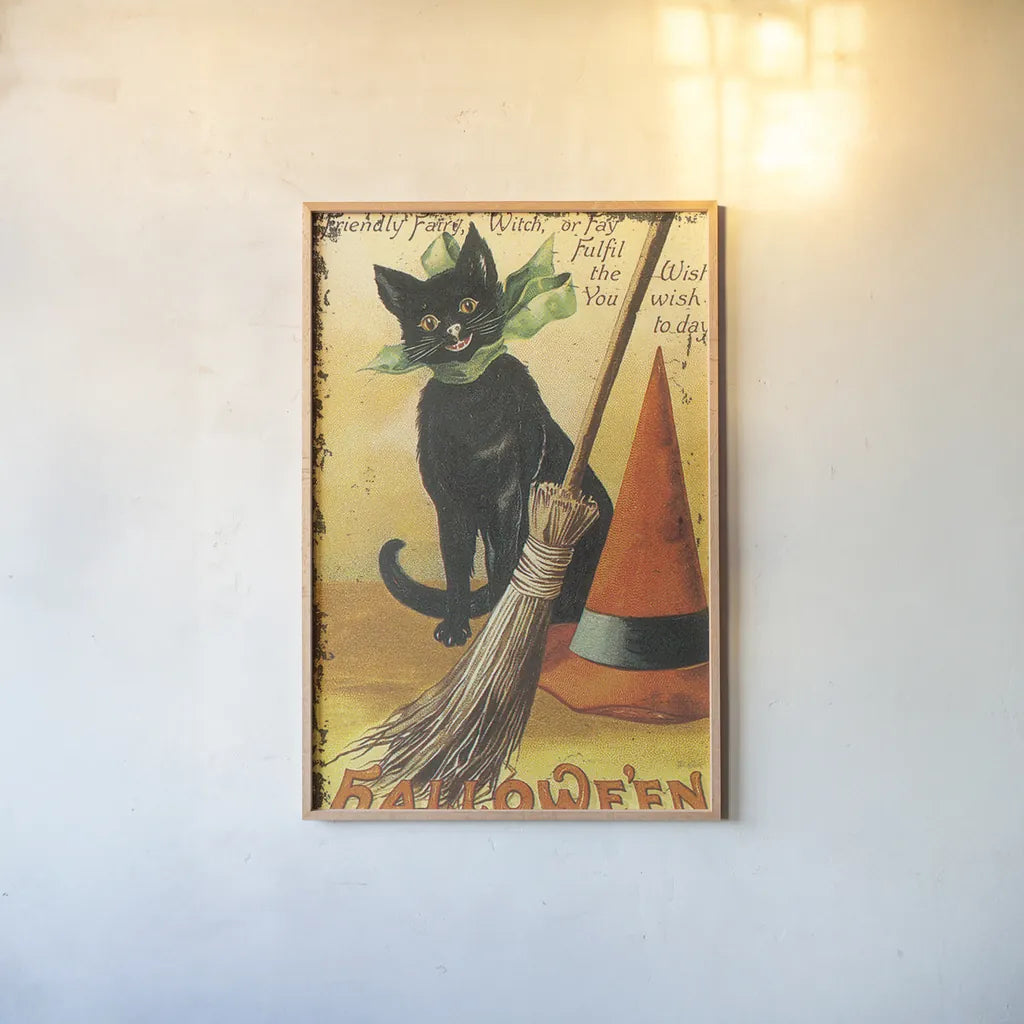 Halloween Nostalgia Cat with Broom by Katie Pertiet. shown as a paper print in a natural frame. Available as a archival giclee rolled canvas, fine art paper, or poster print. SKU 57290h.