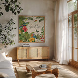 Parrot Paradise IV by Katie Pertiet. Shown in a natural wood frame in a cozy modern living room. Available as an archival giclee rolled canvas, fine art paper, or poster print. SKU 42063a.