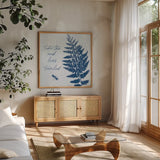 True Blue V by Katie Pertiet. Shown in a natural wood frame in a cozy modern living room. Available as an archival giclee rolled canvas, fine art paper, or poster print. SKU 62865a.
