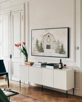 Wooded Holiday I Barn by Katie Pertiet. shown as a framed stretched canvas in a living room above a console. Available as a archival giclee rolled canvas, fine art paper, or poster print. SKU 66636i.