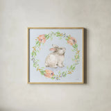 Blooming Bunnies I Blue by Katrina Pete. Shown in a natural wood glass frame for a timeless modern aesthetic. Available as an archival giclee rolled canvas, fine art paper, or poster print. SKU 89676a.