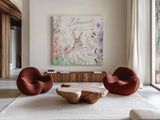 Blooming Bunnies III by Katrina Pete. Shown as extra-large giant wall art in a modern living room. Available as an archival giclee rolled canvas, fine art paper, or poster print. SKU 84607a.