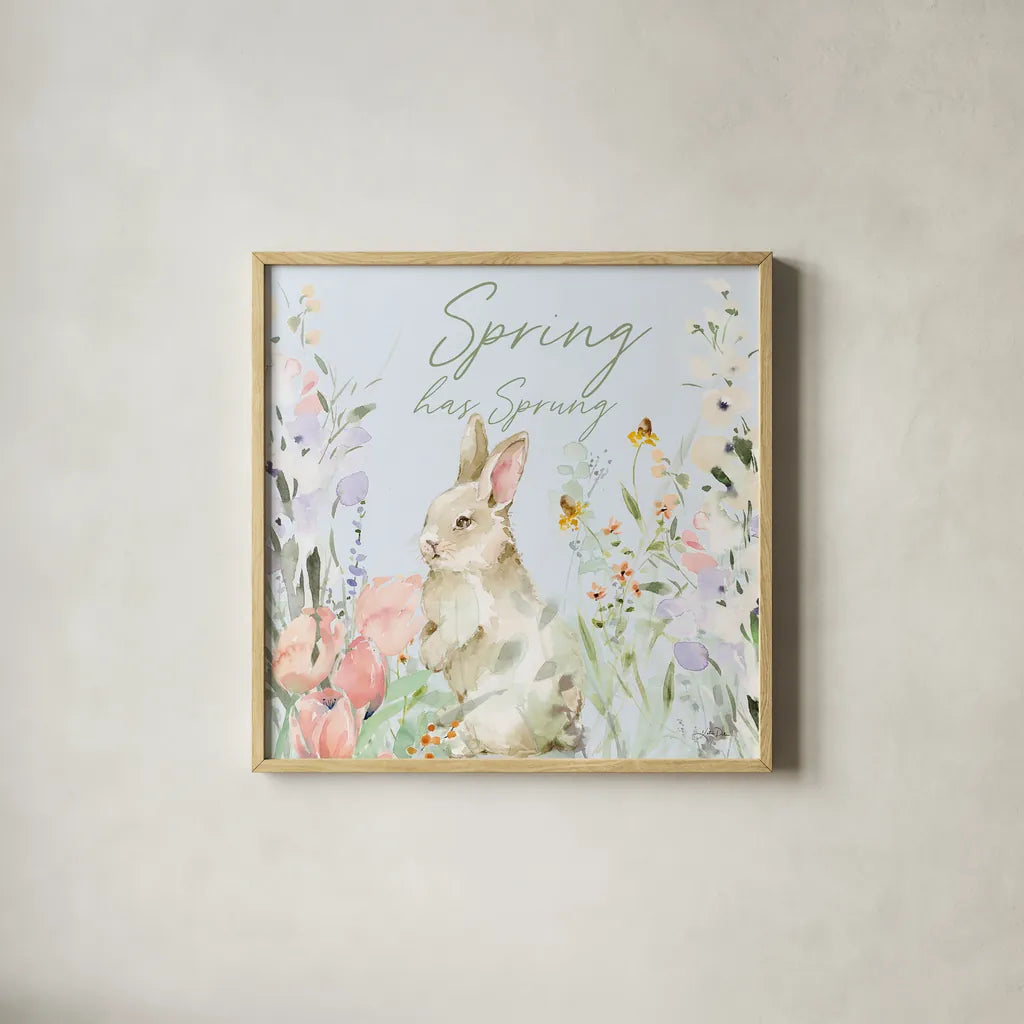 Blooming Bunnies IV Spring by Katrina Pete. Shown in a natural wood glass frame for a timeless modern aesthetic. Available as an archival giclee rolled canvas, fine art paper, or poster print. SKU 89678a.