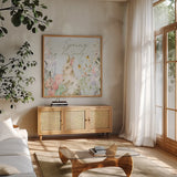 Blooming Bunnies IV Spring by Katrina Pete. Shown in a natural wood frame in a cozy modern living room. Available as an archival giclee rolled canvas, fine art paper, or poster print. SKU 89678a.