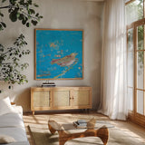 Birds of a Feather v2 Blue by Kellie Day. Shown in a natural wood frame in a cozy modern living room. Available as an archival giclee rolled canvas, fine art paper, or poster print. SKU 36083a.