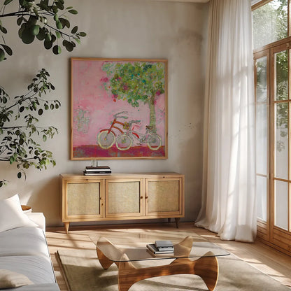 Pink Bicycles by Kellie Day. Shown in a natural wood frame in a cozy modern living room. Available as an archival giclee rolled canvas, fine art paper, or poster print. SKU 39678a.