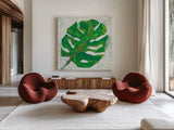 Single Leaf Play on White by Kellie Day. Shown as extra-large giant wall art in a modern living room. Available as an archival giclee rolled canvas, fine art paper, or poster print. SKU 28279a.
