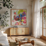 Falling Strawberries by Kristy Rice. Shown in a natural wood frame in a cozy modern living room. Available as an archival giclee rolled canvas, fine art paper, or poster print. SKU 101998a.