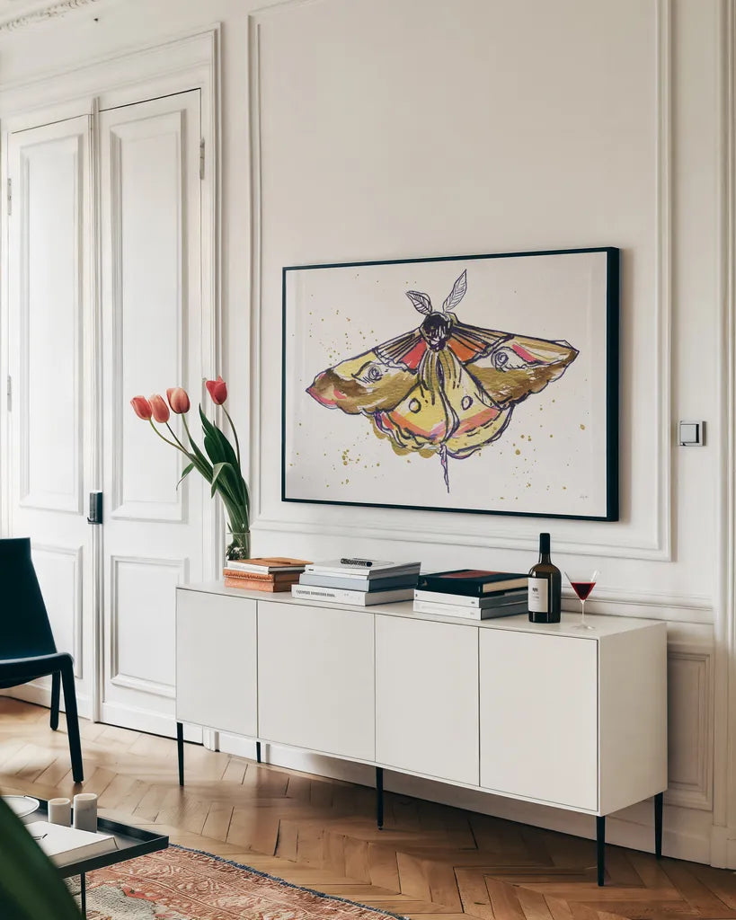 Golden Moth by Kristy Rice. shown as a framed stretched canvas in a living room above a console. Available as a archival giclee rolled canvas, fine art paper, or poster print. SKU 94267i.