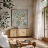 Dogwood Spring I by Krystal Adams. Shown in a natural wood frame in a cozy modern living room. Available as an archival giclee rolled canvas, fine art paper, or poster print. SKU 103646a.