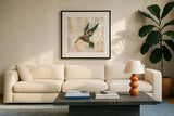 Gilded Wings II by Krystal Adams. Displayed in a glass frame with matte in a clean modern living room. Available as an archival giclee rolled canvas, fine art paper, or poster print. SKU 104880a.